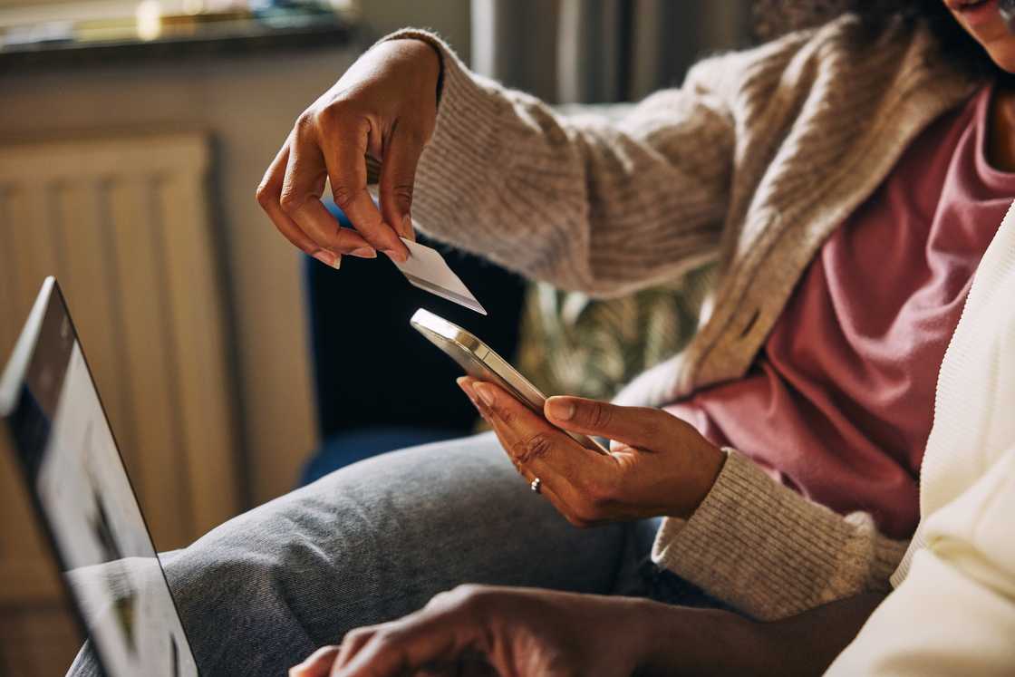 A lady holds a credit card