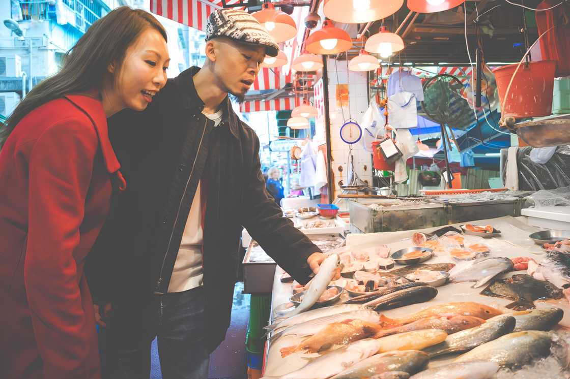 A woman buying fish in the market A woman buying fish in the market
