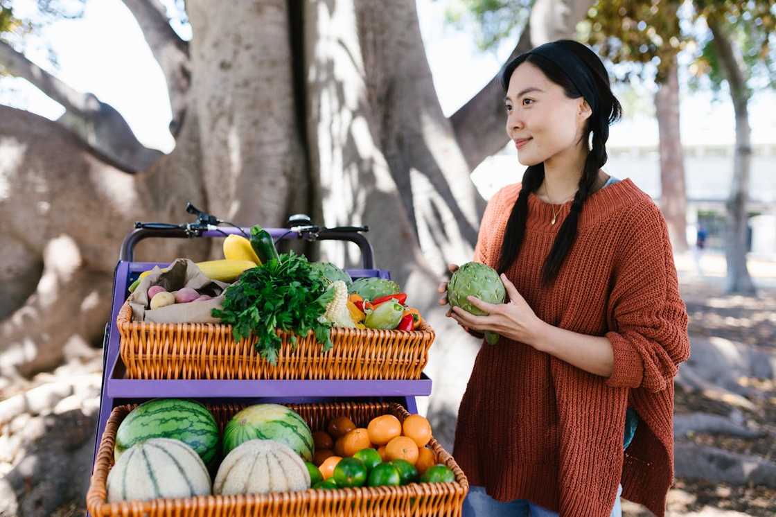 Woman buying food from a roadside market vendor.