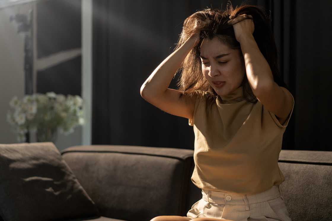 An upset woman sitting on a couch