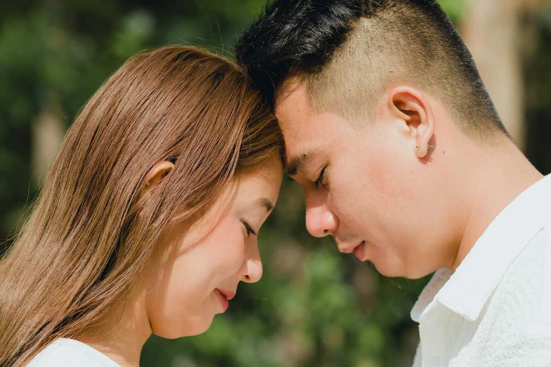 A couple tenderly touching foreheads A couple tenderly touching foreheads