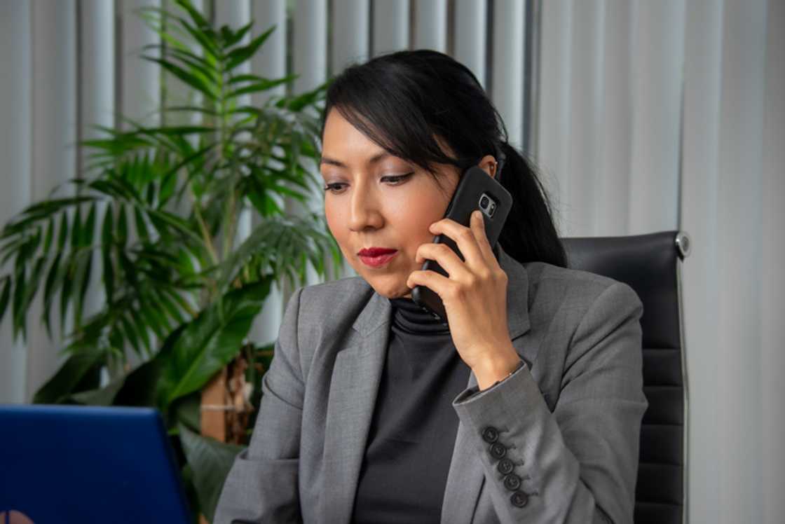 Novels Asian corporate woman in the office on the phone. Novels Asian corporate woman in the office on the phone.