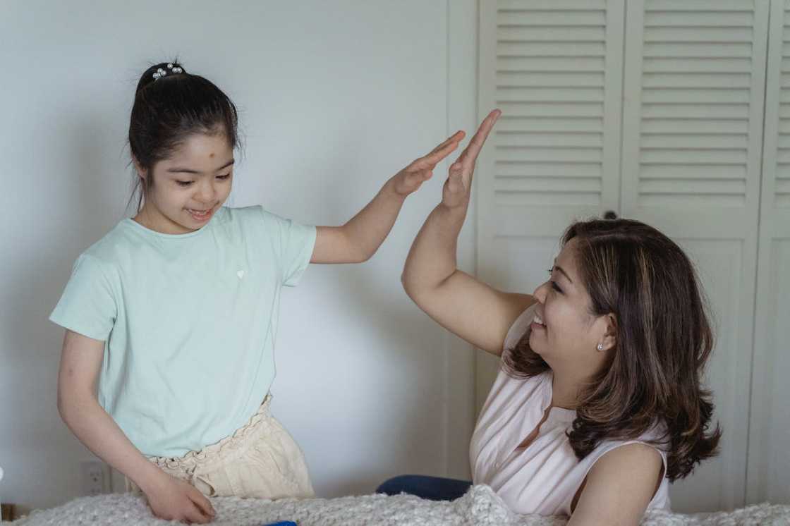 Parents admire their freshly painted children's bedroom. Parents admire their freshly painted children's bedroom.