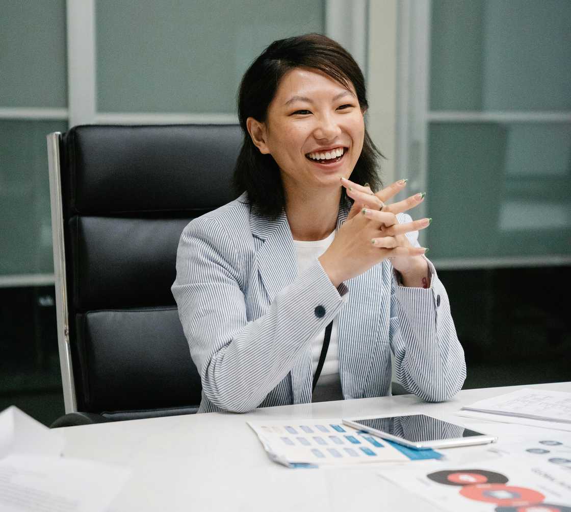A woman laughing during a conversation A woman laughing during a conversation