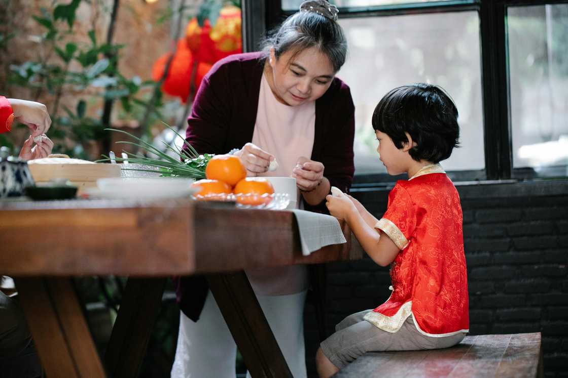 A mother preparing a meal with her son A mother preparing a meal with her son