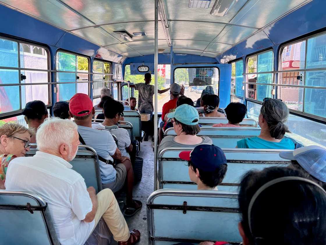 Passengers seated inside a crowded public bus. Passengers seated inside a crowded public bus.