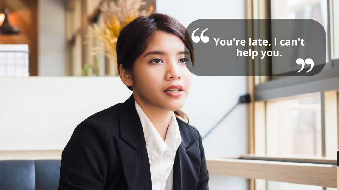 A young woman sitting in office talking to someone A young woman sitting in office talking to someone