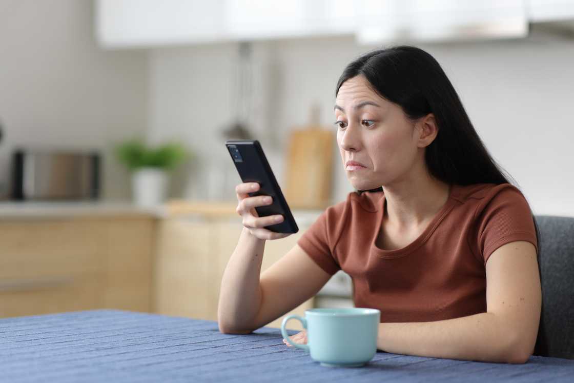 A perplexed woman checking phone A perplexed woman checking phone