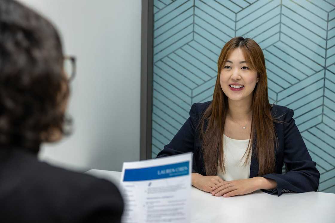 A woman candidate during an interview in a corporate boardroom.