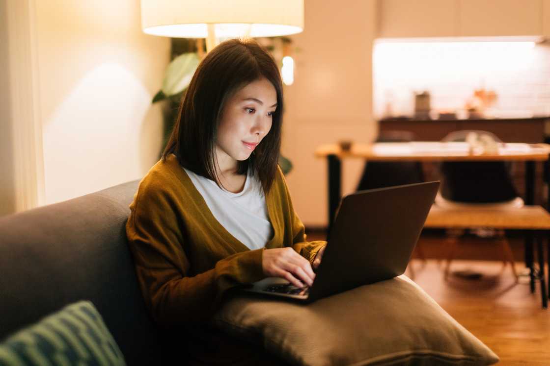 A lady scrolling through her laptop A lady scrolling through her laptop