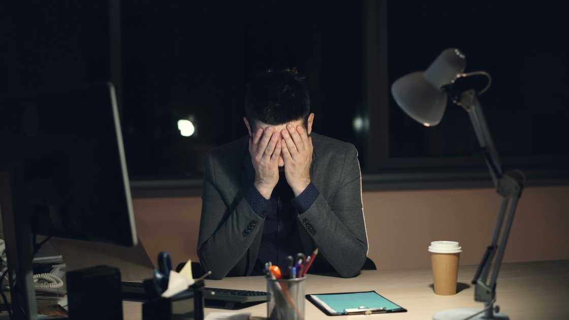 A stressed man in the office at night