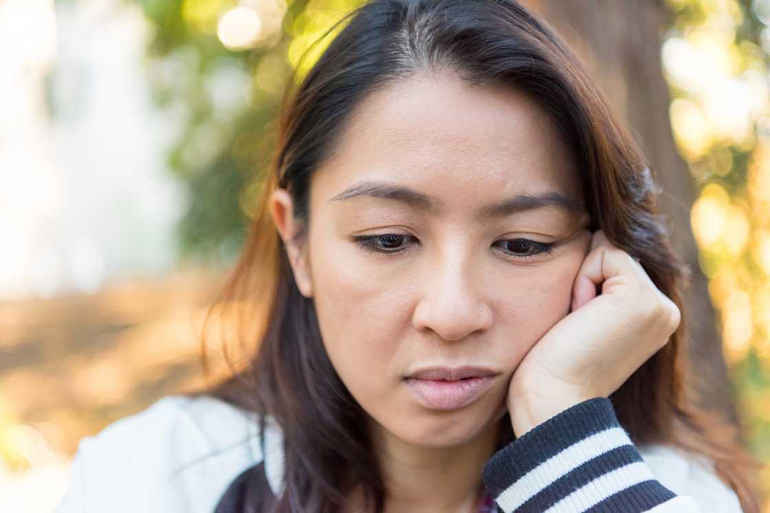 A worried woman looking down