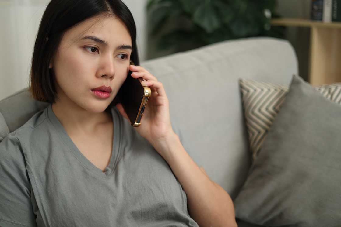 A young woman talking on the phone A young woman talking on the phone