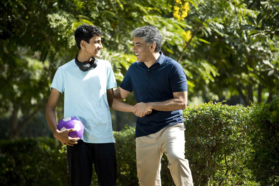 A father with his son spending leisure time at a park A father with his son spending leisure time at a park