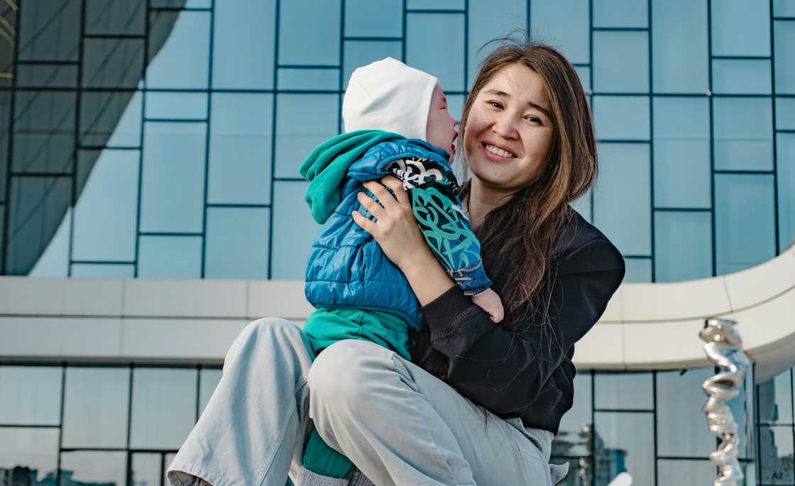 A woman cuddling with a toddler