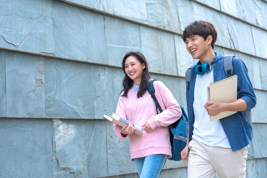 A couple walking past a library
