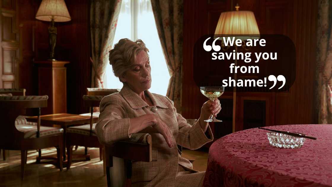 An elderly woman holding a wine glass and staring pensively into space. An elderly woman holding a wine glass and staring pensively into space.