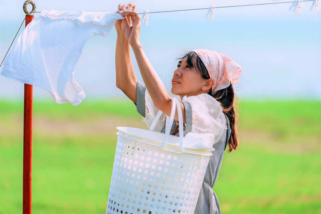 Woman hanging up wet clothes Woman hanging up wet clothes