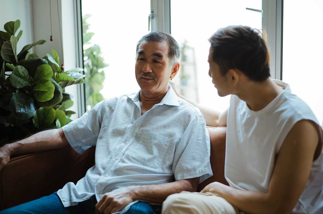 A father and his adult son are chatting