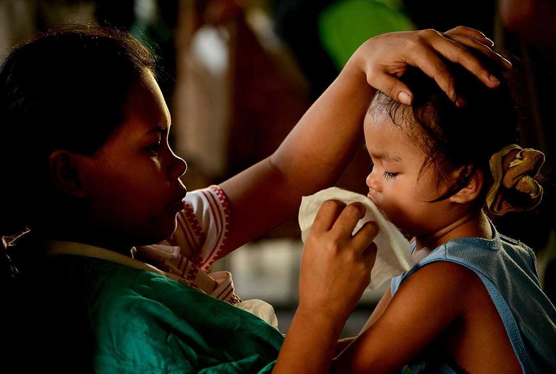 A mother wiping her daughter's tears