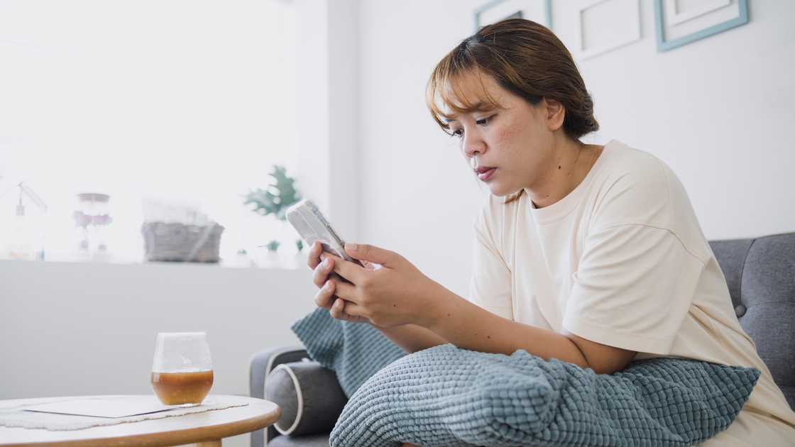 A lady is scrolling on her phone A lady is scrolling on her phone
