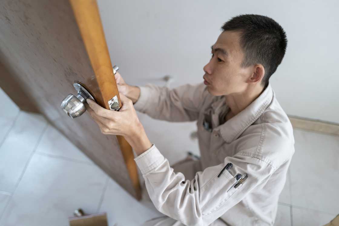 A locksmith fixing the door