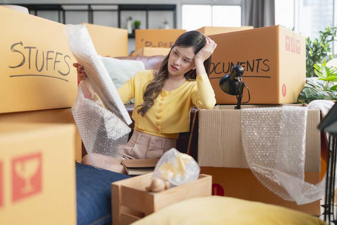 A woman moving houses in boxes