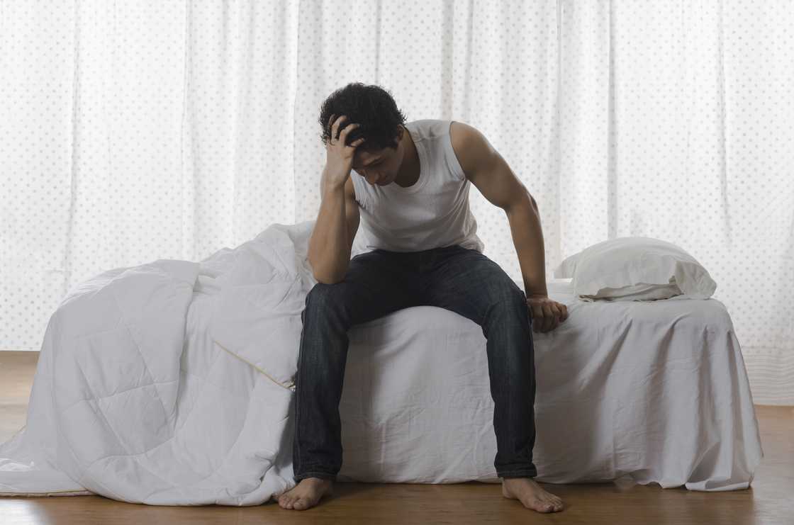 A stressed man in bed