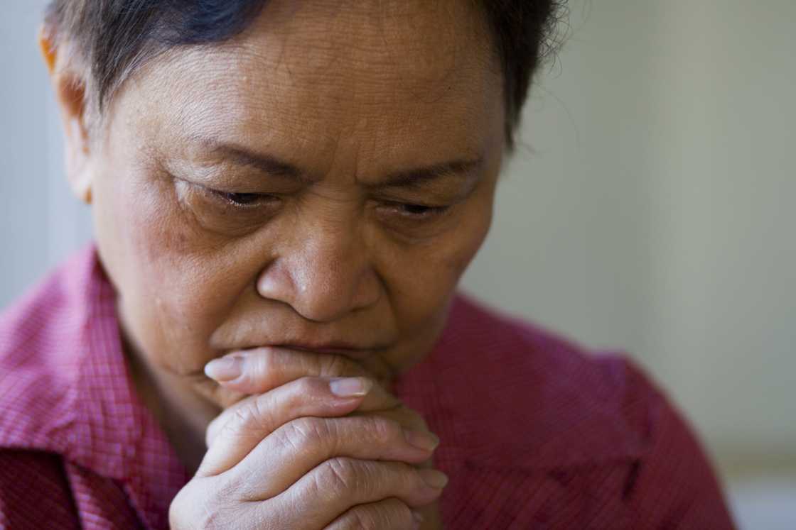 A sad elderly Asian woman