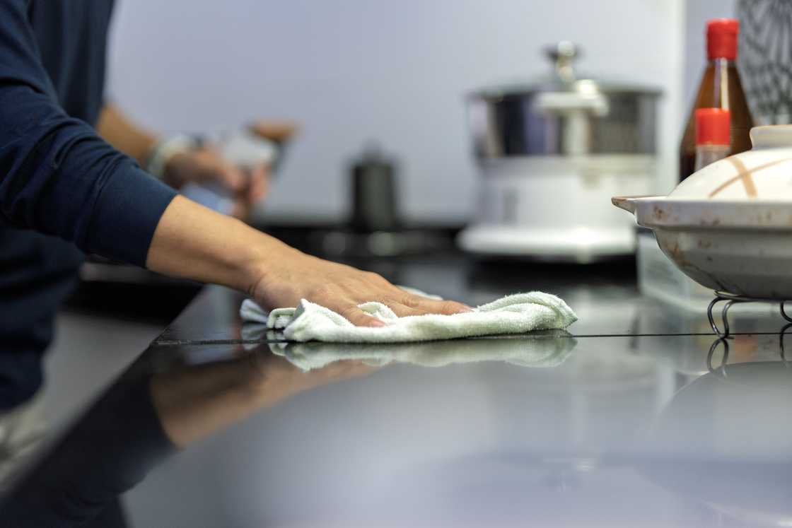 A man wipes the kitchen counter