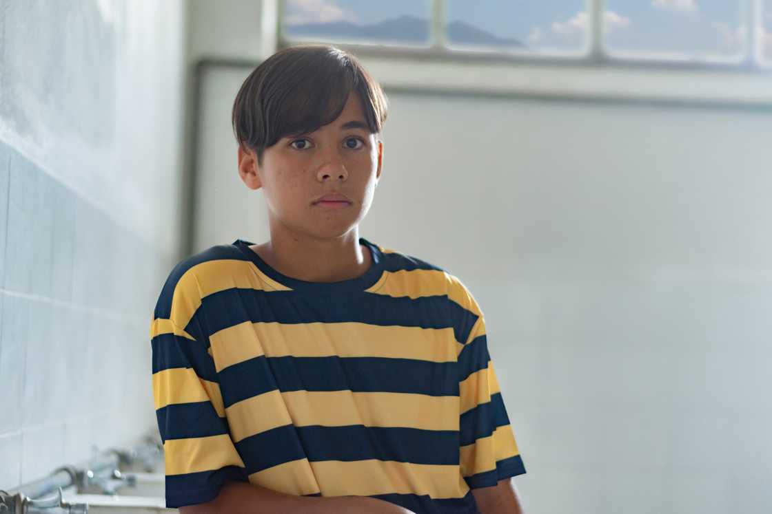 A disappointed teenage boy sitting at home A disappointed teenage boy sitting at home