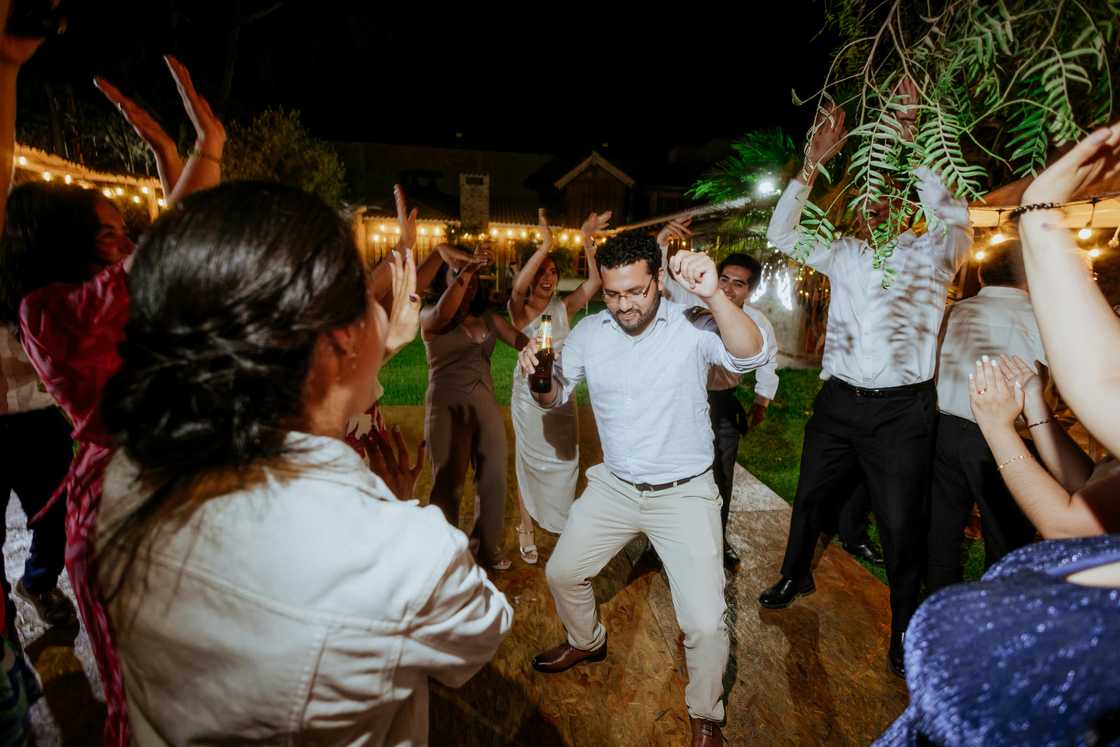 Groom enjoying celebration with friends and guests