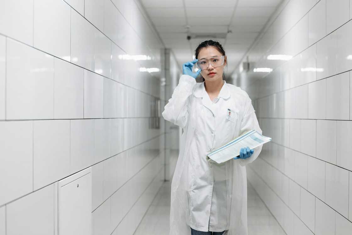 A scientist holding research papers