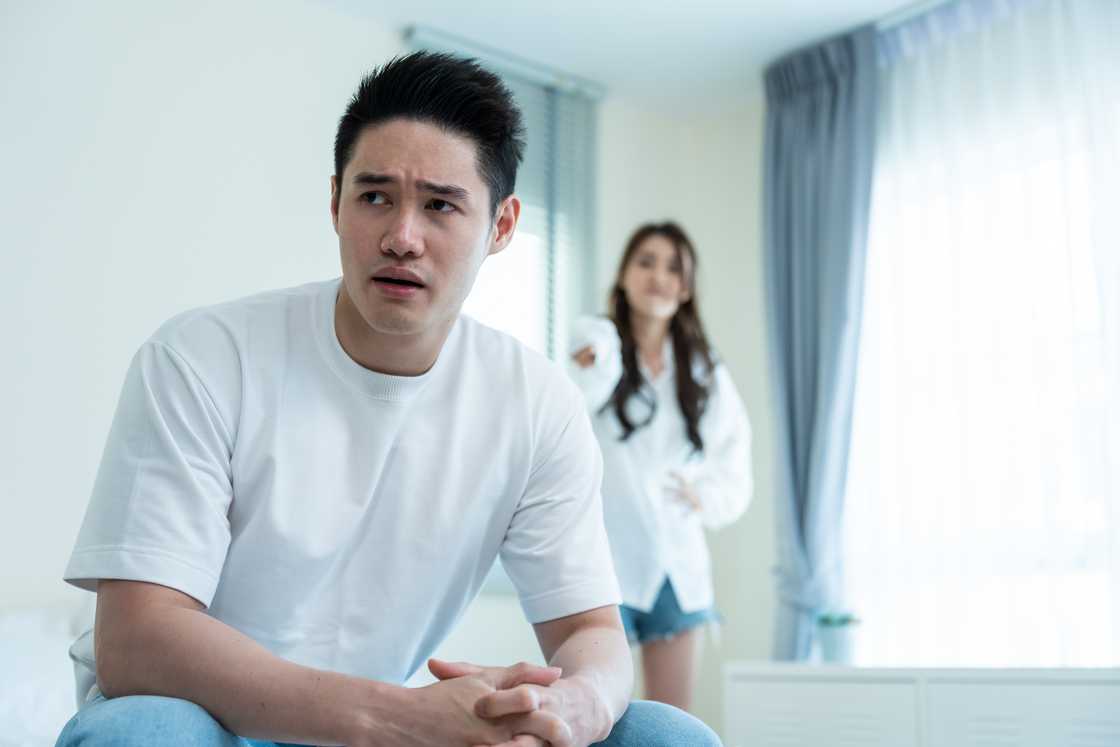 A boyfriend and girlfriend having arguing in the bedroom