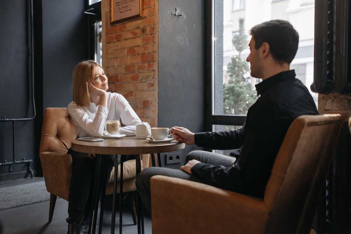 Man and woman talking over coffee in a café. Man and woman talking over coffee in a café.