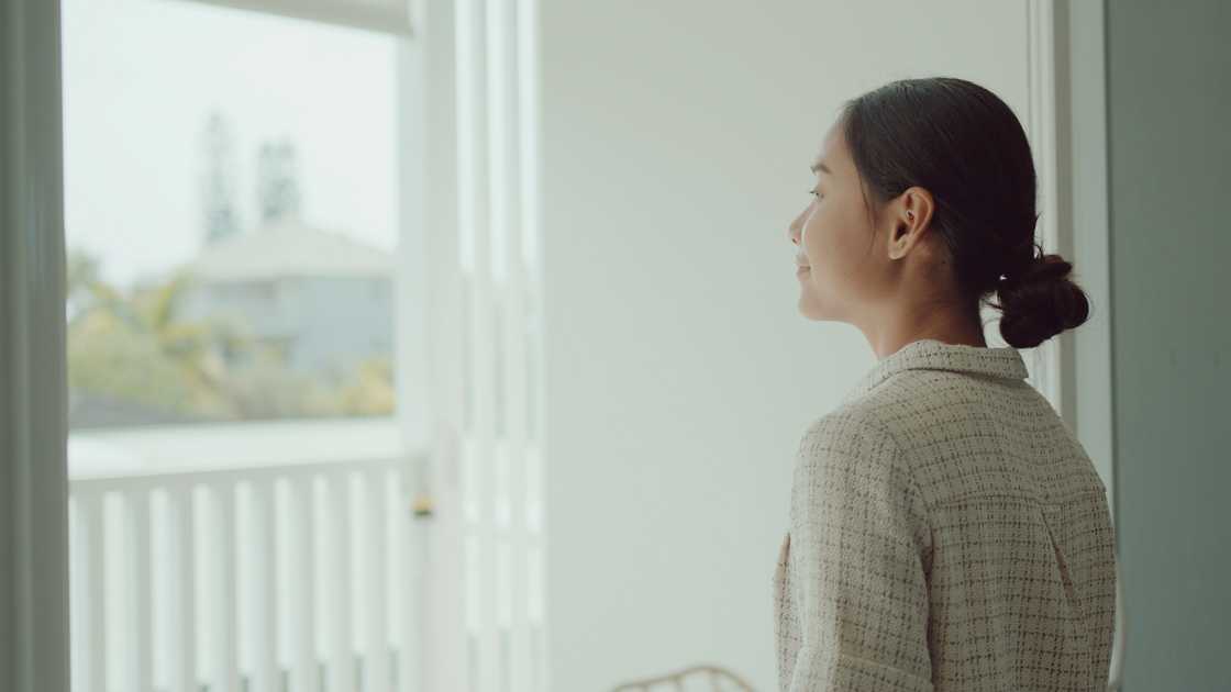 A young woman looking out of a window