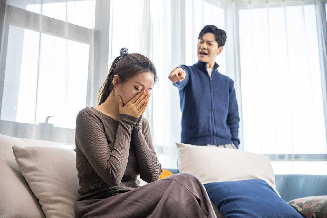 A frowning woman arguing with her husband A frowning woman arguing with her husband