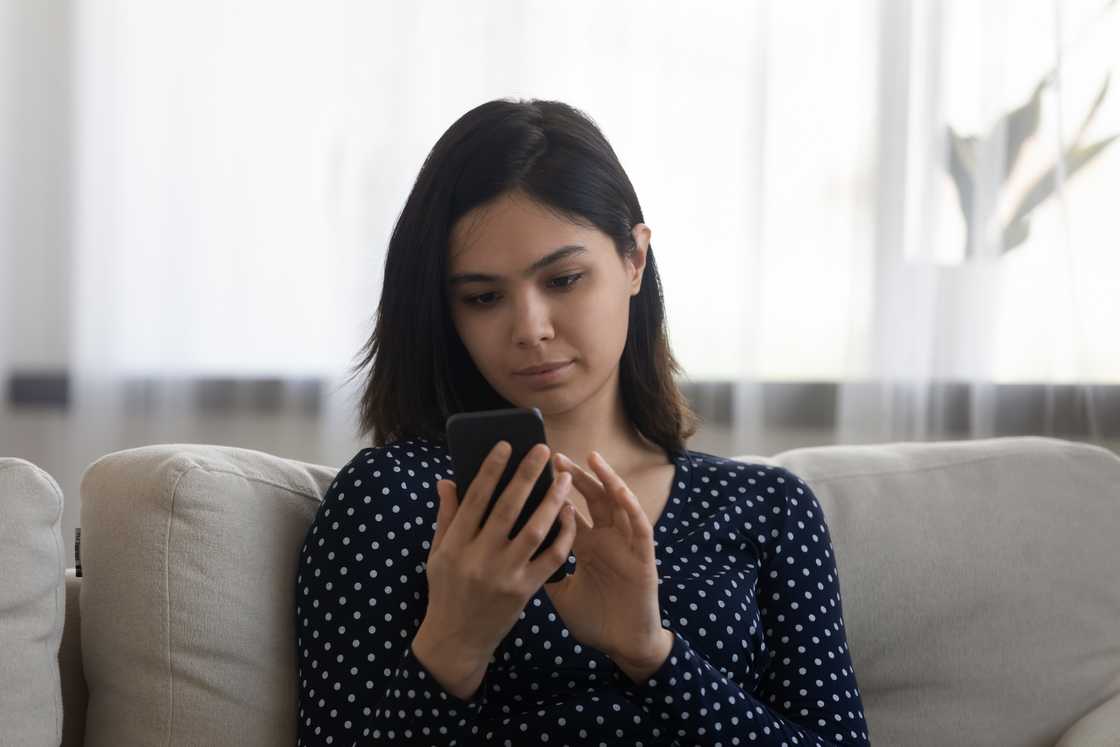 A woman scrolls through a phone A woman scrolls through a phone