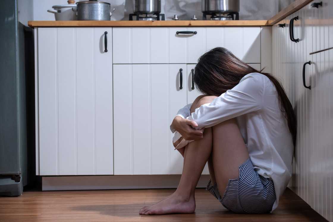 A woman weeping in the kitchen
