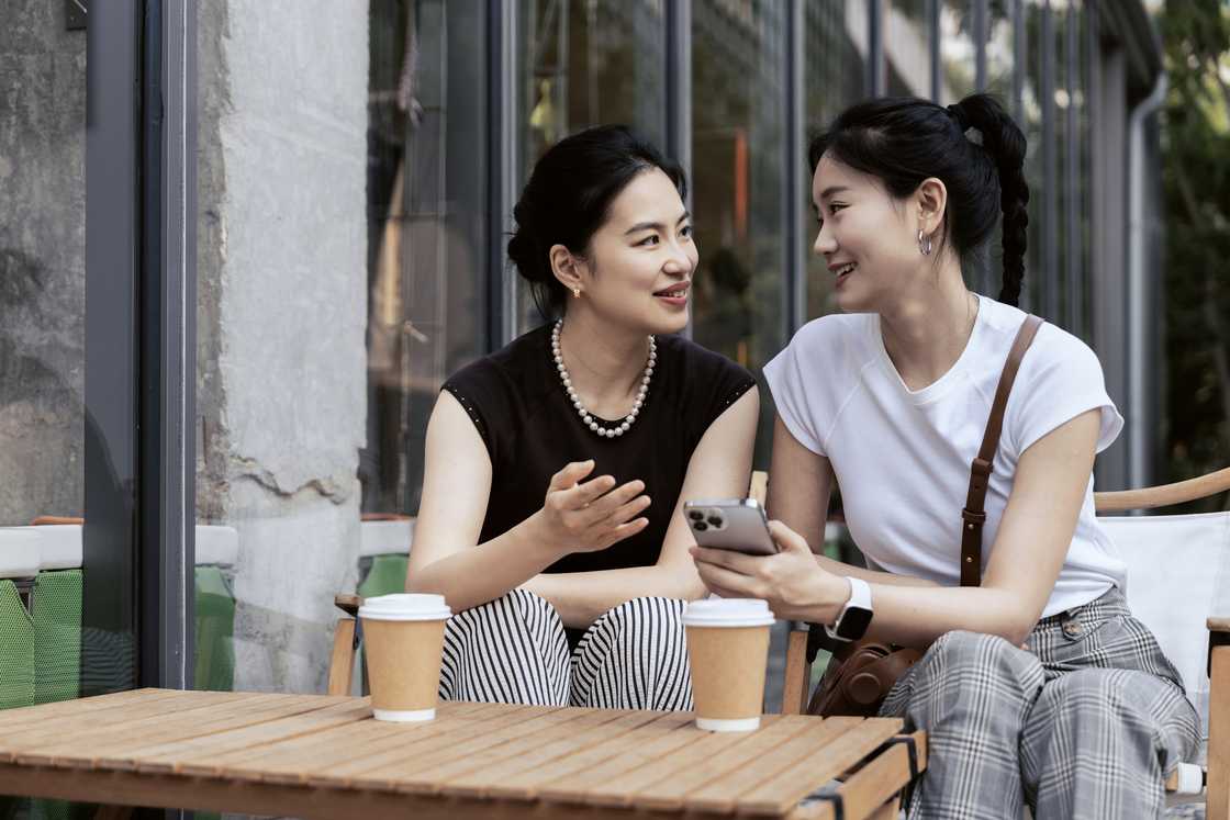 Two friends at a cafe talking