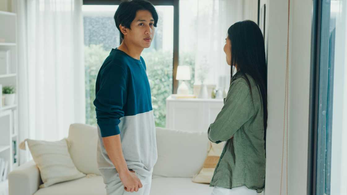 A man and woman quarreling in living room at home A man and woman quarreling in living room at home