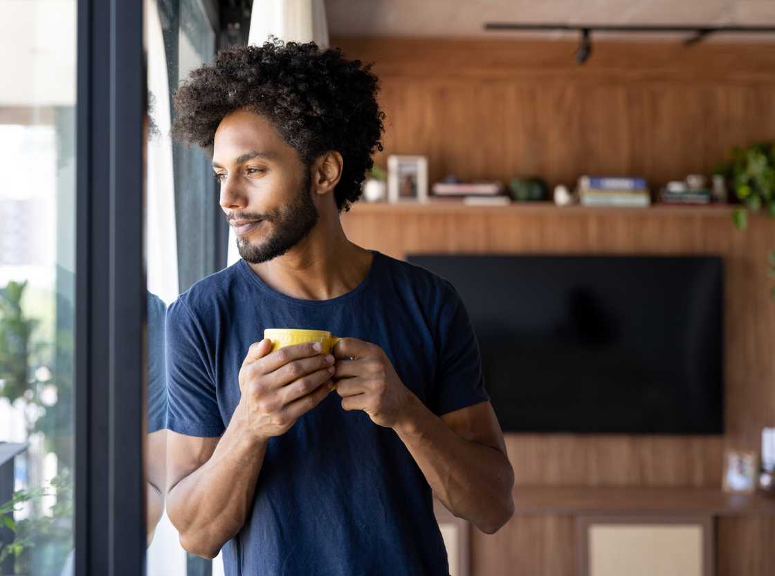 A happy man drinking a cup of coffee A happy man drinking a cup of coffee