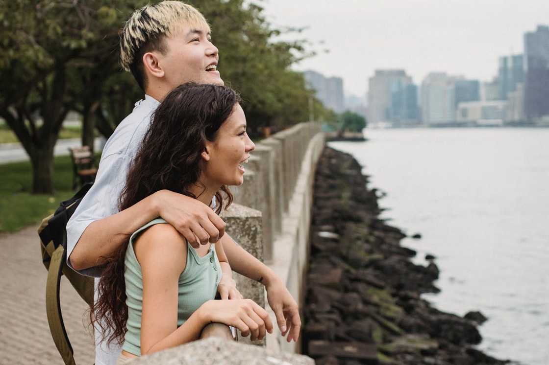 A couple stand on an embankment, admiring the surroundings. A couple stand on an embankment, admiring the surroundings.