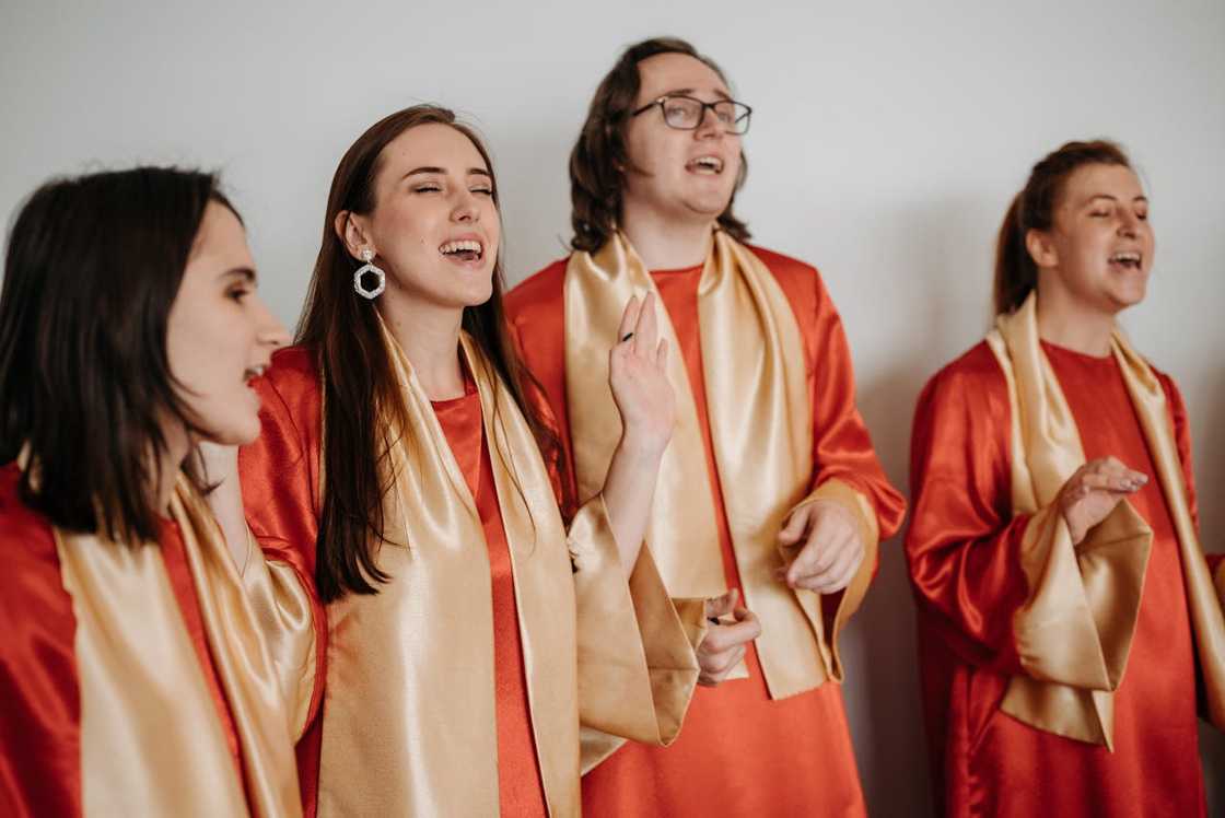 A group of people sing together inside a church setting.