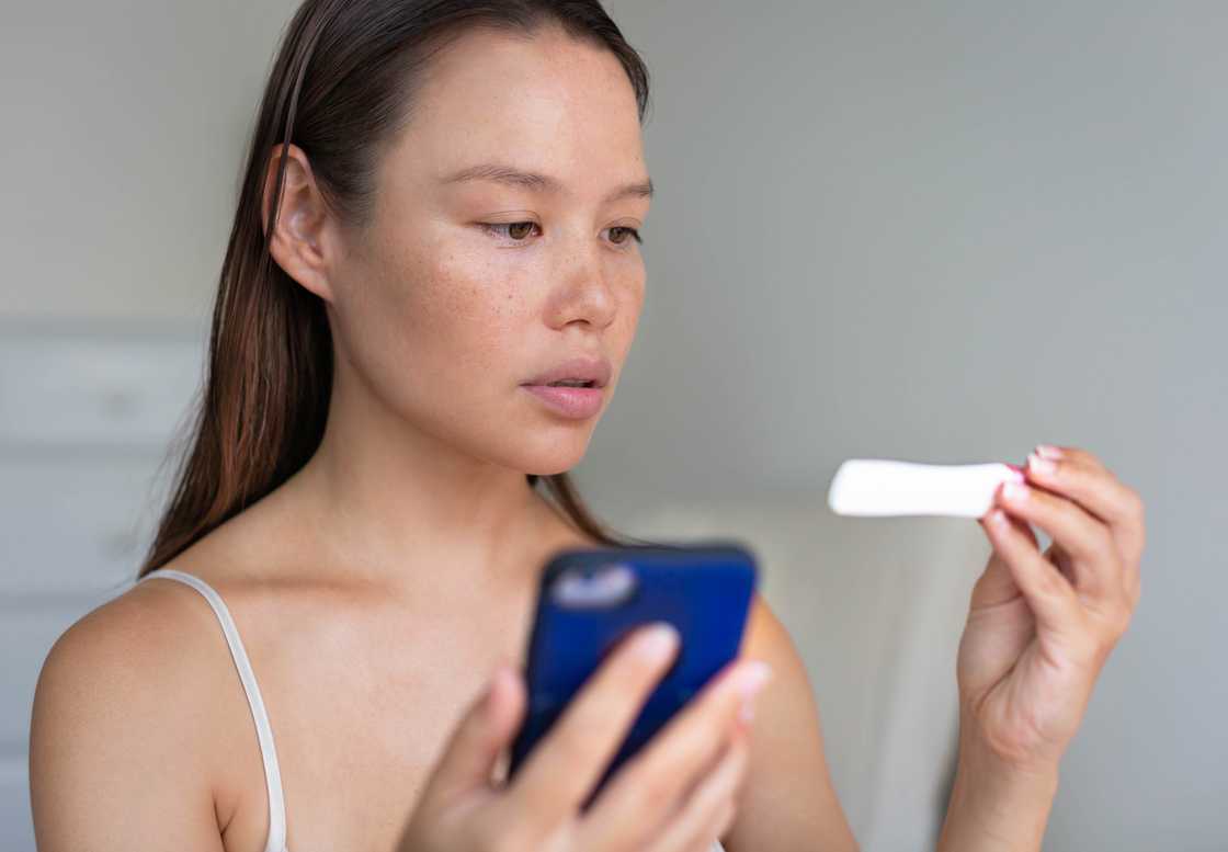 A lady holds a pregnancy test