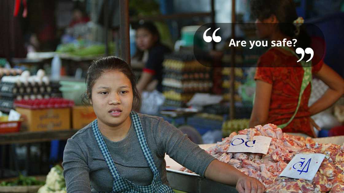 A saleswoman in the market talking to someone A saleswoman in the market talking to someone