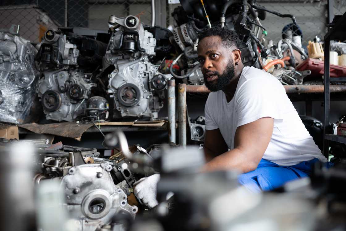 A mechanic in a white tee A mechanic in a white tee