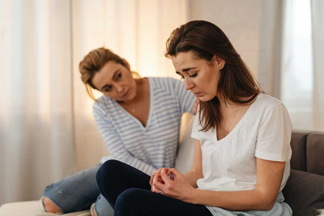 Female friend consoling a worried woman