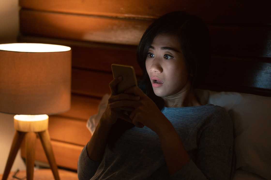 Novels Shocked Asian Woman Staring at Phone