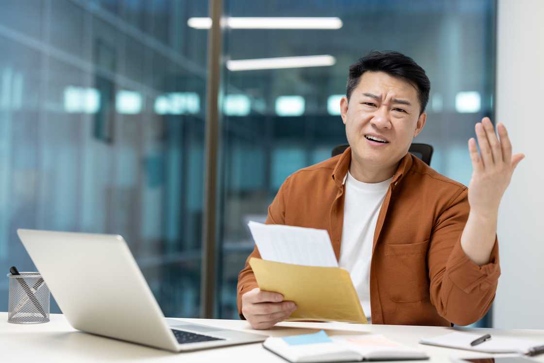 A man holding a thick document